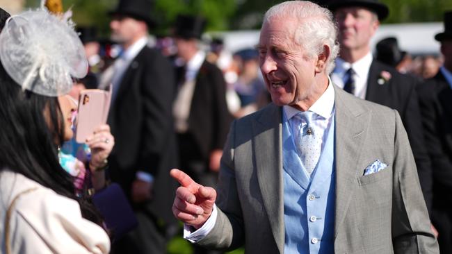 King Charles speaks to guests attending a Royal Garden Party at Buckingham Palace on Wednesday. Picture: Getty Images