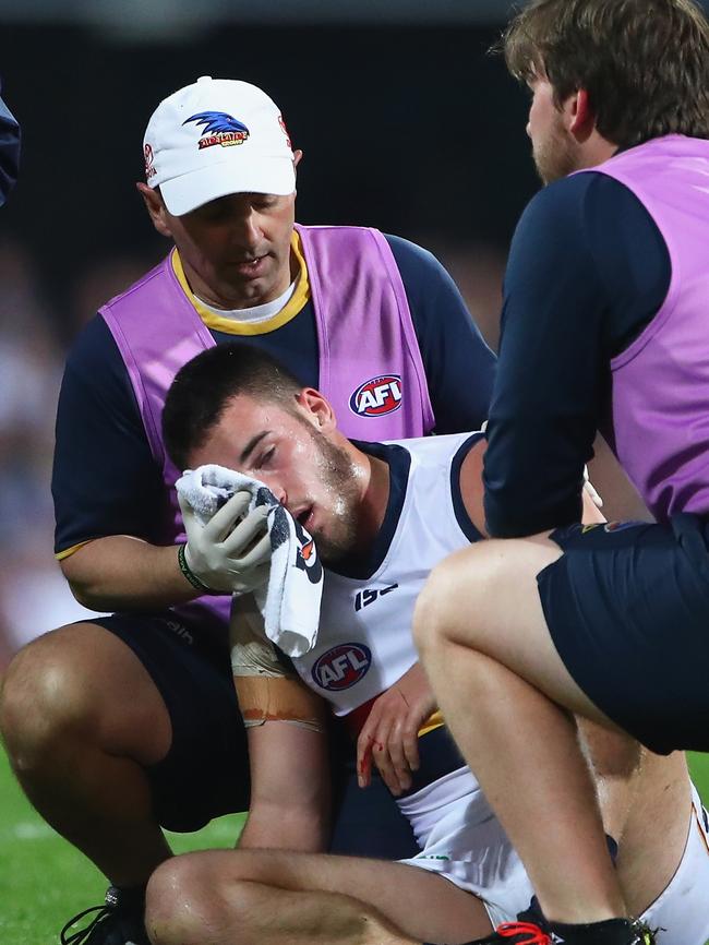 Lachlan Murphy in the hands of trainers after his heavy collision. Picture: Jason O'Brien/AFL Media/Getty Images