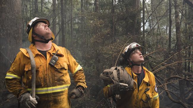 Kingston volunteer Stuart Conway and Huonville volunteer Tom Andrews take a break after halting the fire in the Tahune area. Picture: WARREN FREY/TFS