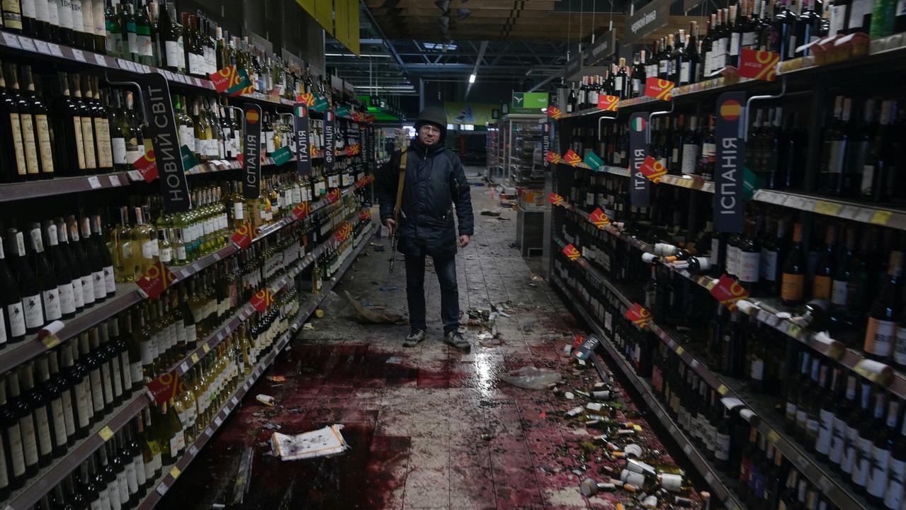 A member of the Ukrainian Territorial Defence Forces stands inside a supermarket in the town of Bucha in the Kyiv region on February 28, 2022. Picture: Maksim Levin/Reuters