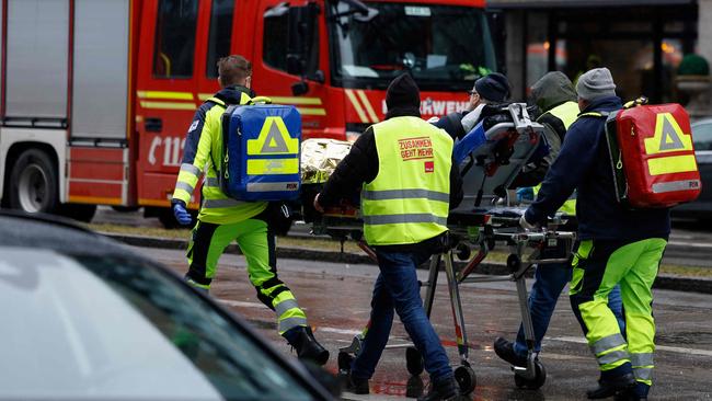 Paramedics wheel an injured person on a stretcher after the suspected car ramming attack. Picture: Michaela Stache / AFP