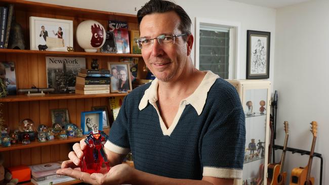 B105 radio host Stav Davidson holding his Swarovski crystal superman in his favourite part of the house close to his guitars and figurines, The Gap. Picture: Liam Kidston