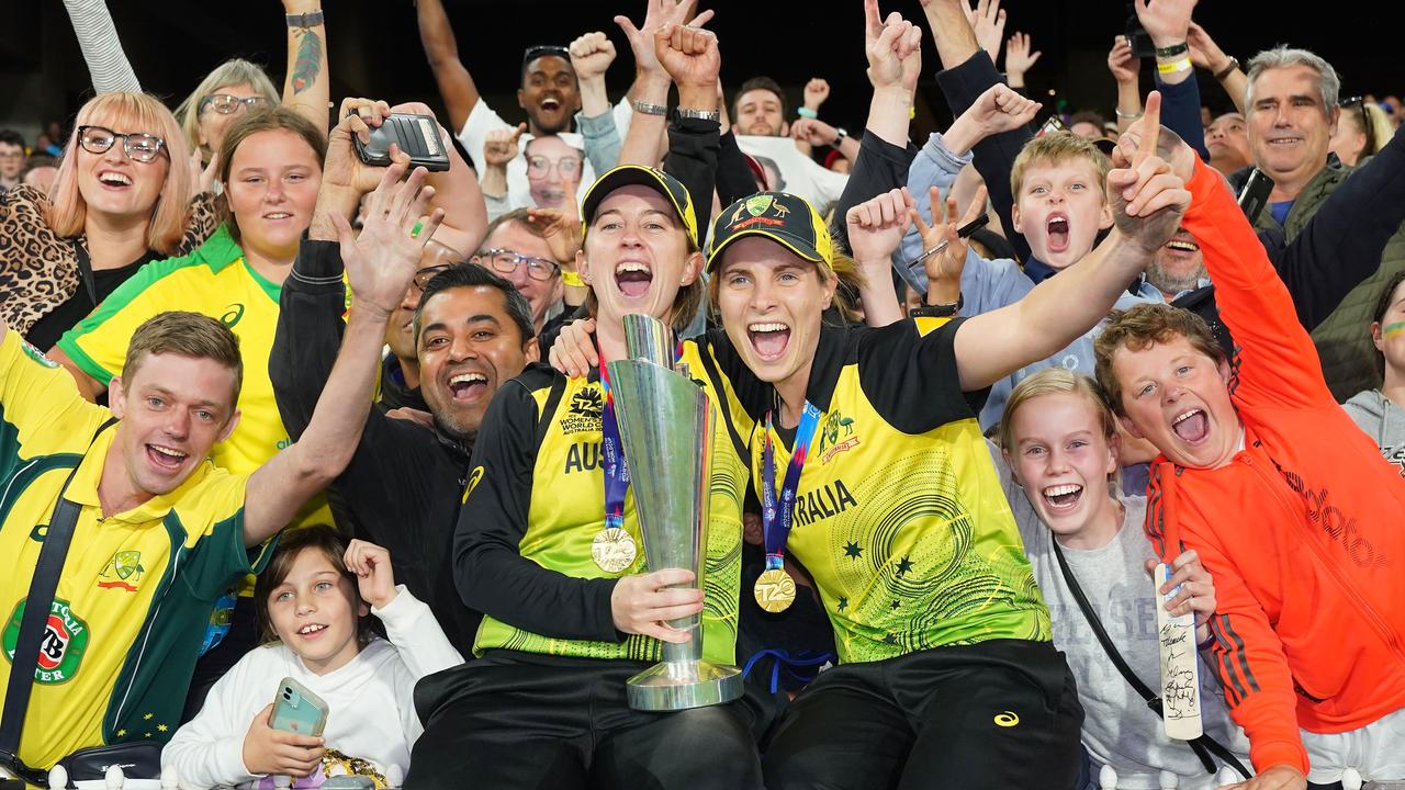 Rachael Haynes and Sophie Molineux of Australia celebrate with the trophy after winning the Women's T20 World Cup final match. AAP Image/Scott Barbour