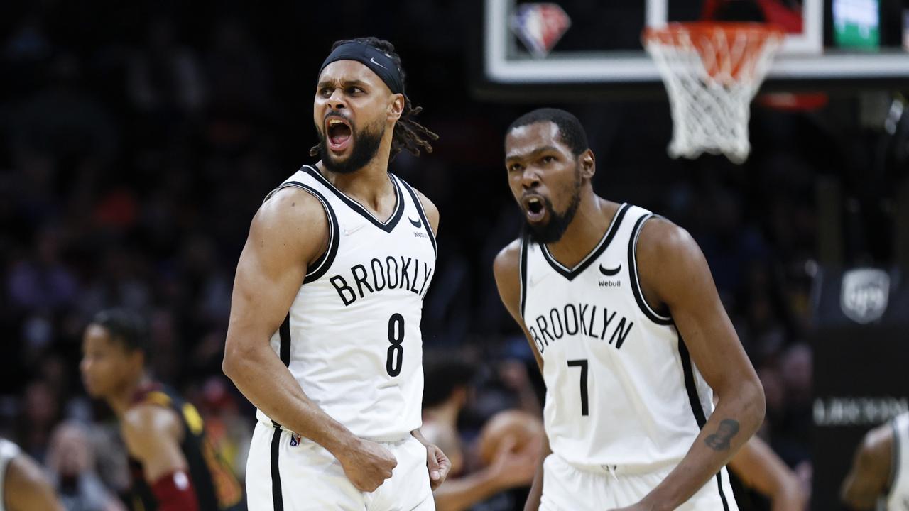 CLEVELAND, OH - NOVEMBER 22: Patty Mills #8 and Kevin Durant #7 of the Brooklyn Nets react after a made shot against the Cleveland Cavaliers during the second half at Rocket Mortgage Fieldhouse on November 22, 2021 in Cleveland, Ohio. The Nets defeated the Cavaliers 117-112. NOTE TO USER: User expressly acknowledges and agrees that, by downloading and or using this photograph, User is consenting to the terms and conditions of the Getty Images License Agreement. (Photo by Ron Schwane/Getty Images)