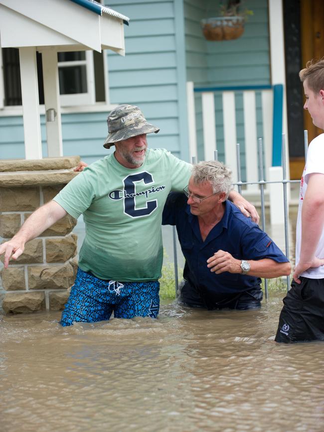 Persons in the flood hit Brisbane suburb of Yeronga evacuate their property Wednesday, January 12, 2011.