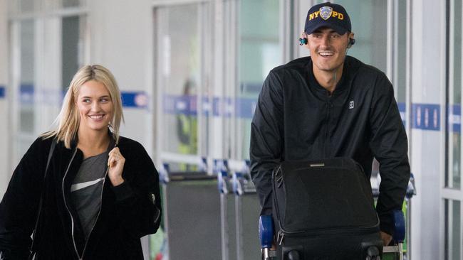 Bernard Tomic arrives Melbourne airport with his girlfriend Emma Blake-Hahnel. Picture: Splash News