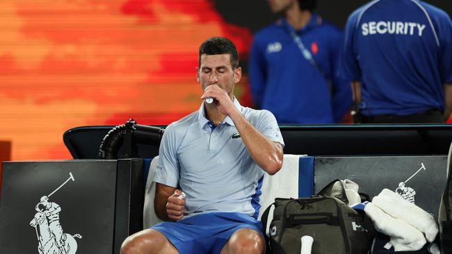 Novak Djokovic hydrates as he takes a break during his fourth-round win. Picture: AFP