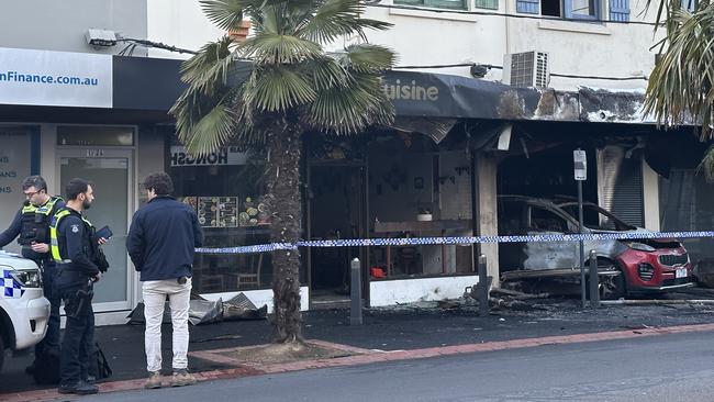 Police at the scene of a burnt out tobacco store in Oakleigh on Thursday morning.