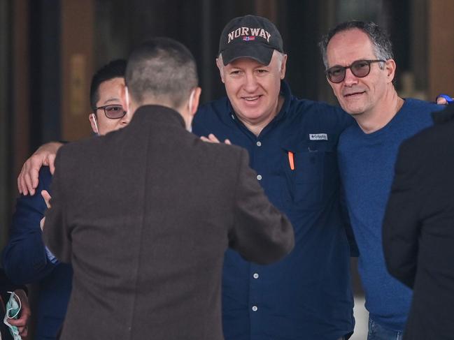 WHO team members Marion Koopmans (L), Peter Daszak (3rd R) and Peter Ben Embarek (2nd R) pose for a picture as Koopmans and Daszak leave their hotel after the World Health Organization (WHO) team wrapped up its investigation into the origins of the COVID-19 coronavirus in Wuhan in China's central Hubei province on February 10, 2021. (Photo by Hector RETAMAL / AFP)