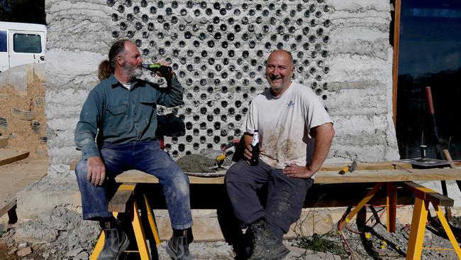 Mark van Laarhoven (R), pictured with friend Kris Allen, is building a house out of bottles and tyres. Picture: Toby Zerna