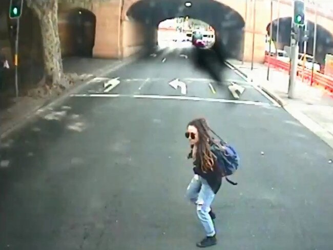 The woman ran in front of a bus that had waited for a green light at Eddy Ave.