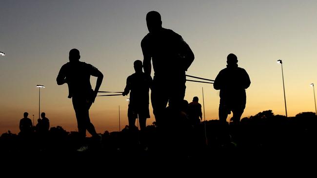 Eels players go through their warm-up at a twilight training session at the Old Saleyards Reserve at North Parramatta on Wednesday evening. Picture. Phil Hillyard