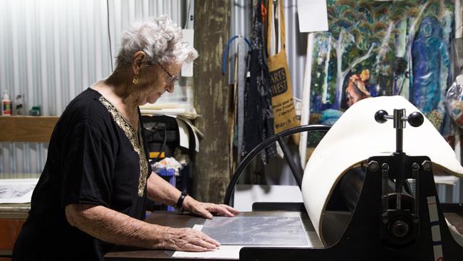 Artist Ellie Neilsen with her treasured press in her studio at Morayfield. Photo: Dominika Lis