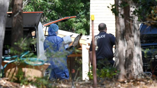 A police forensic officer (left) tends to the scene of the alleged double murder of Frank and Loris Puglia in Joyner in Brisbane's north on May 18, 2020. Picture: AAP Image/Dan Peled