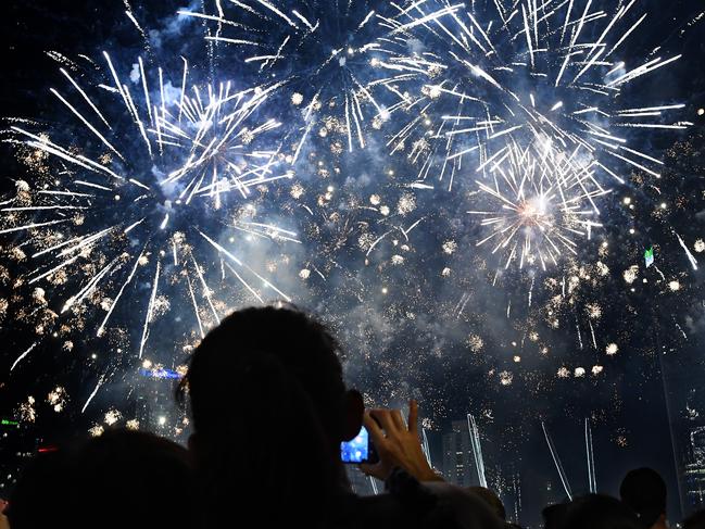 Crowds watch a fireworks display during New Year's Eve celebrations in Brisbane. Picture: AAP