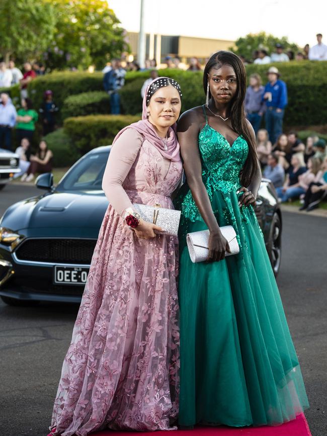 Parisa Aziz Ahmed (left) and Nyangeu Angui arrive at Harristown State High School formal at Highfields Cultural Centre, Friday, November 18, 2022. Picture: Kevin Farmer