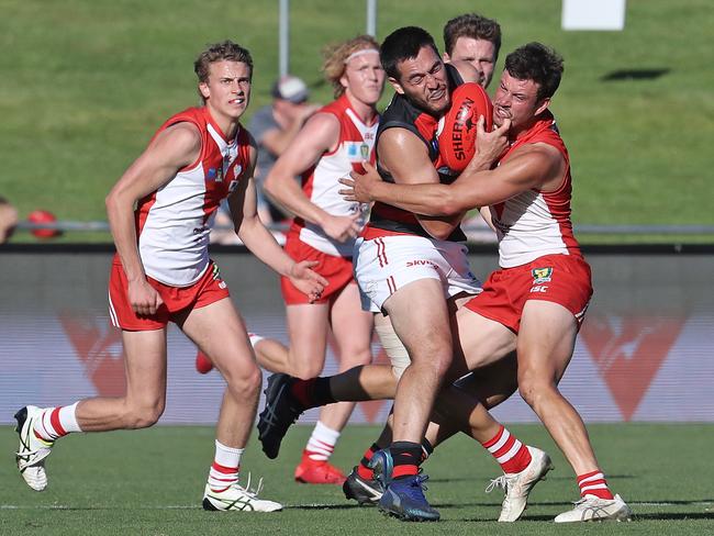 Lauderdale's Phillip Bellchambers is wrapped up in a tackle by Clarence's Gabriel Chambers, in a Clarence vs Lauderdale match at Blundstone Arena on Saturday. Picture: LUKE BOWDEN