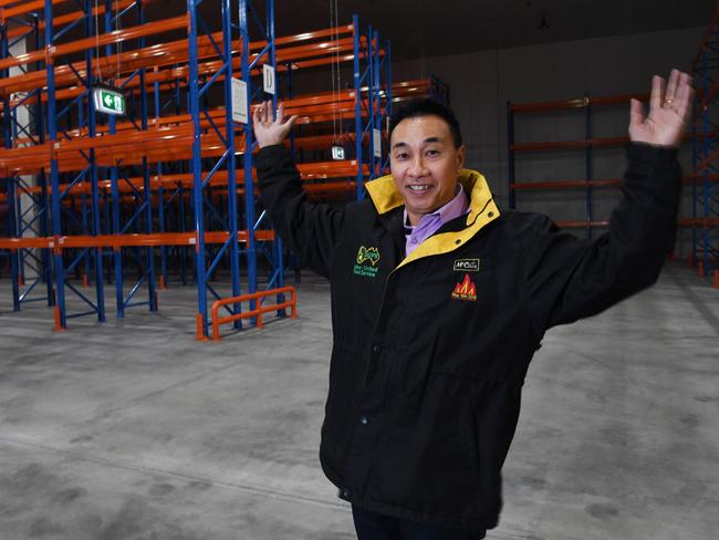 Nelson Lay proudly stands in the new Asian United Food premises after it was burnt to the ground last year. Picture: Katrina Bridgeford