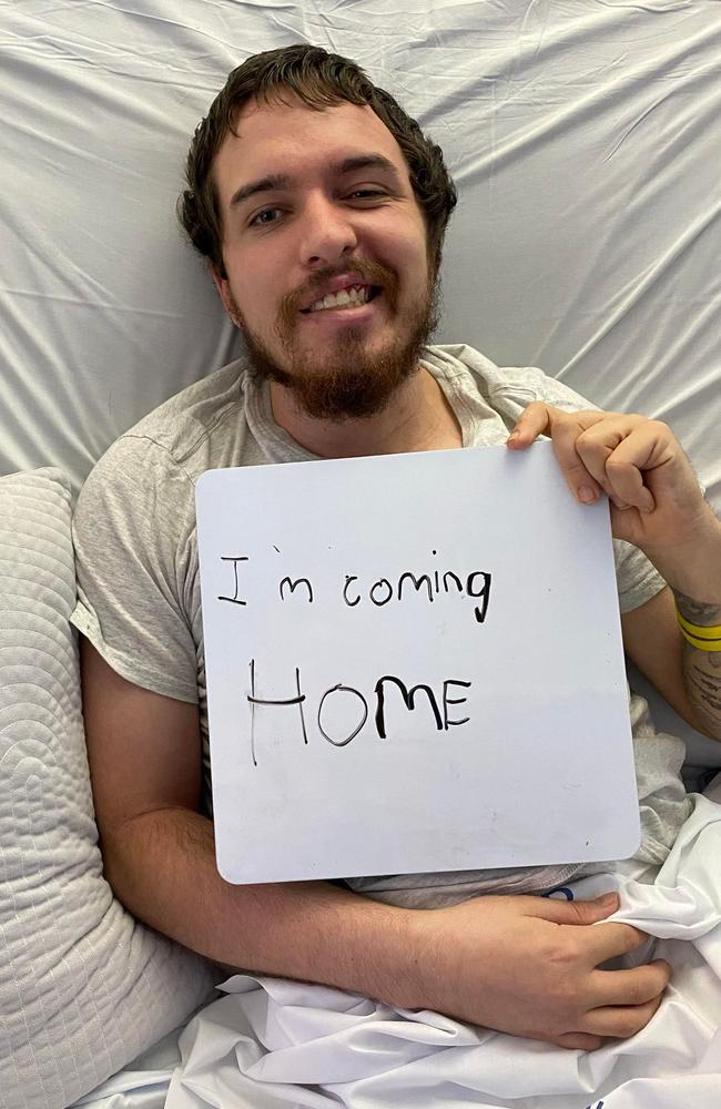 Jake Ferrier the day he left hospital (he wrote the sign). Picture – contributed.