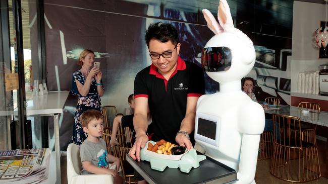 Manager Kenny Lee and robot waitress Shelley deliver food to customers at Ringwood’s Spacewalk Cafe. Picture: Mark Dadswell