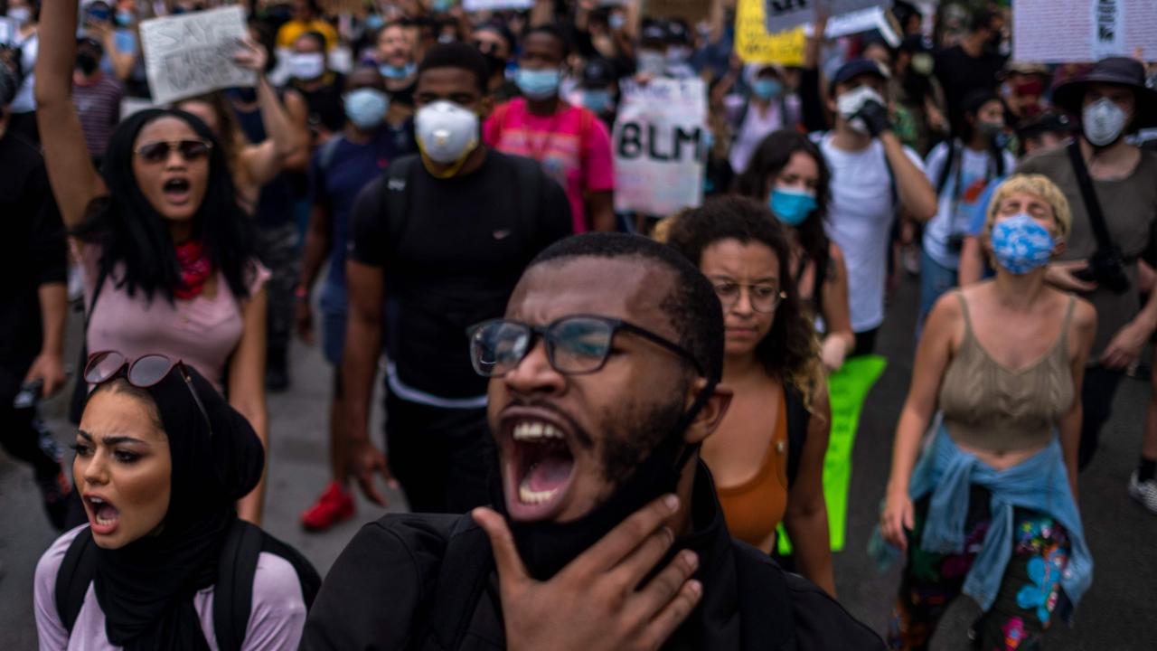 Protesters march holding up placards and chanting slogans during a rally in Miami, Florida. Picture: Ricardo Arduengo/AFP