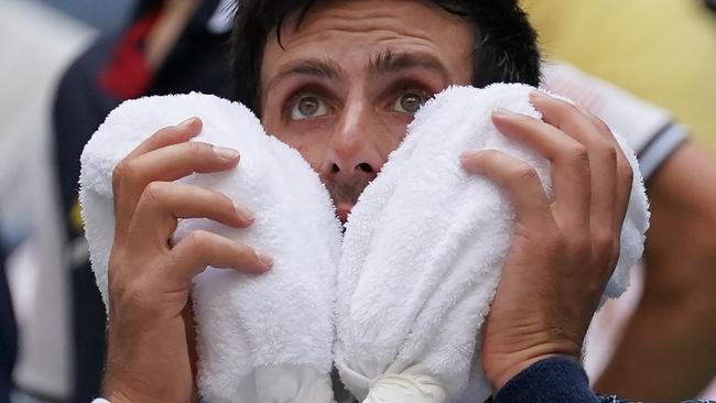 Novak Djokovic of Serbia takes a break from the heat while playing against Marton Fucsovics of Hungary during their Day 2 2018 US Open Men's Singles match at the USTA Billie Jean King National Tennis Center in New York on August 28, 2018. (Photo by TIMOTHY A. CLARY / AFP)