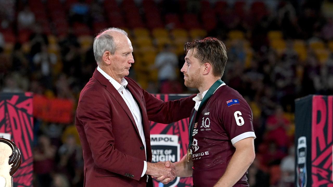 BRISBANE, AUSTRALIA - NOVEMBER 18: Cameron Munster of the Maroons is presented with the man of the match award by Maroons coach Wayne Bennett after game three of the State of Origin series between the Queensland Maroons and the New South Wales Blues at Suncorp Stadium on November 18, 2020 in Brisbane, Australia. (Photo by Bradley Kanaris/Getty Images)