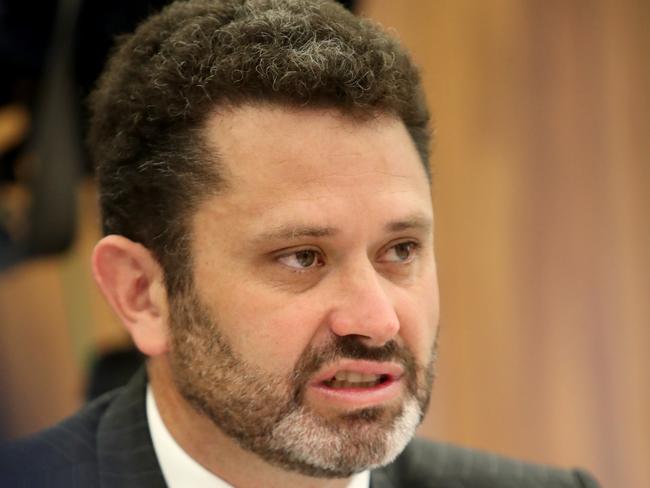 Committee chairman Kyam Maher questions freed murder suspect Henry Keogh during a South Australian parliamentary inquiry at Parliament House in Adelaide, Monday, November 5, 2018. Mr Keogh, who spent more than 20 years in jail for the 1994 murder of Anna-Jane Cheney, on Monday gave evidence to the inquiry, which is looking at the basis for the payment. (AAP Image/Kelly Barnes) NO ARCHIVING