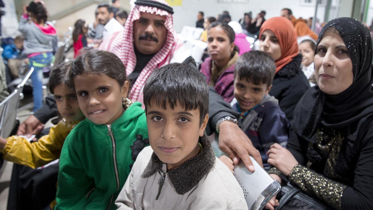 A family from Aleppo in the Australian section of the UNHCR Refugee Registration Centre in Khilda, Jordan waiting to have their biometrics taken as part of resettlement screening. Picture: Ella Pellegrini