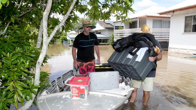 Ian Leabeater with Nick Pirie, unloading stuff from dingy of Ian’s brothers rental house, Graceville Ave. Graceville, Brisbane. Photo: Steve Pohlner