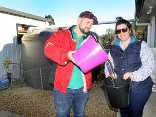 EASING THE LOAD: Jack and Amy Conroy from Woodford are offering up their full water tank to a farmer in need in Stanthorpe. Picture: Contributed