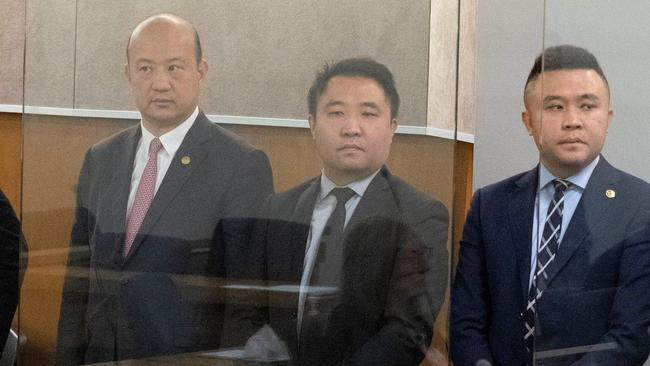 Yikun Zhang (L), Joe and Colin Cheng in court.