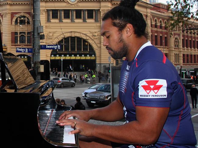 Melbourne Rebels prop Fereti Sa'aga serenades the streets of Melbourne on a grand piano.