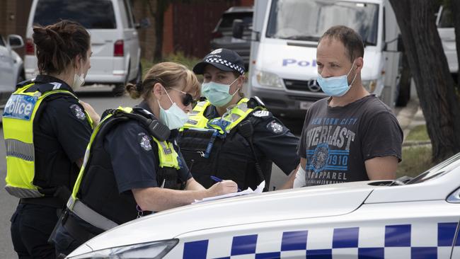 Neighbours talk to police at the scene. Picture: David Geraghty