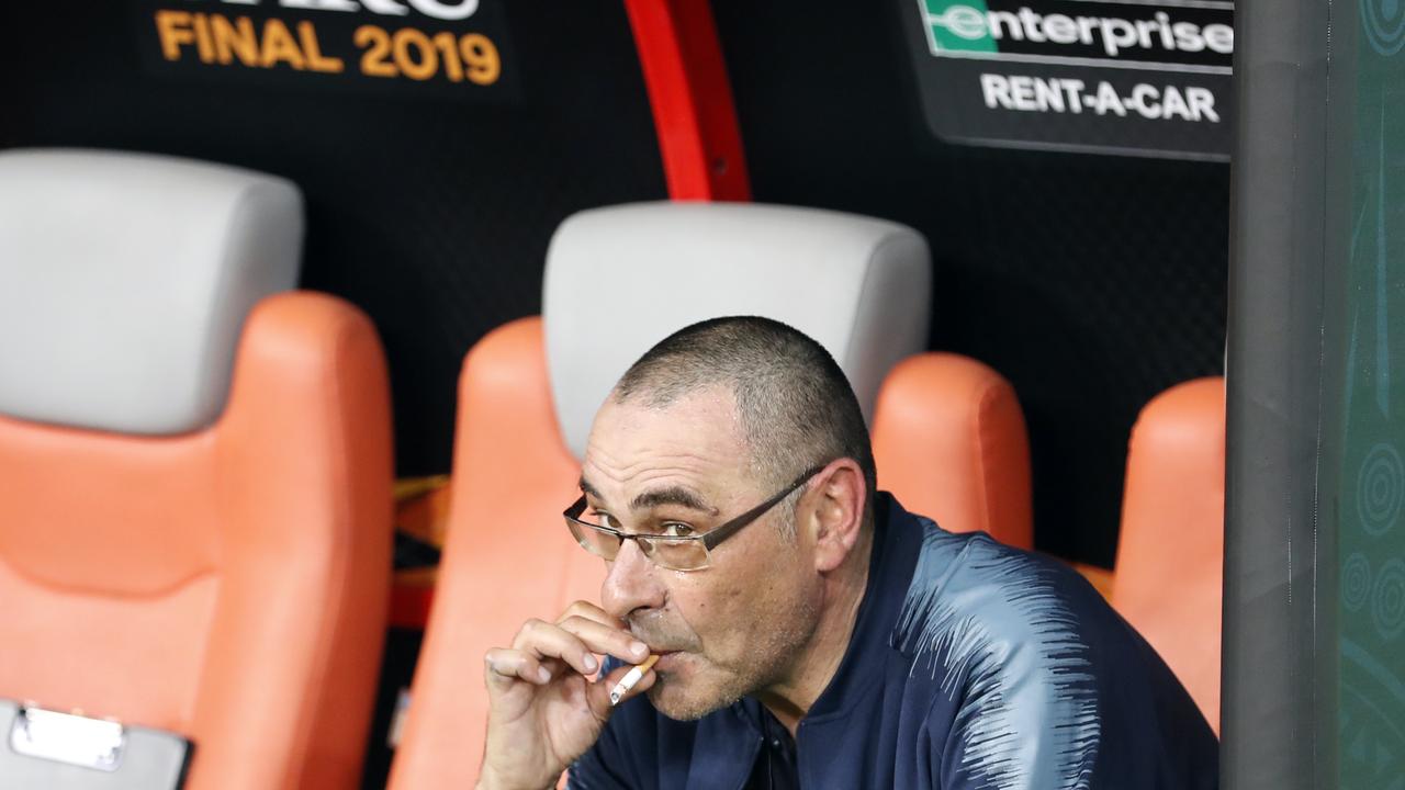 Maurizio Sarri smokes a cigarette on the bench after winning the Europa League final