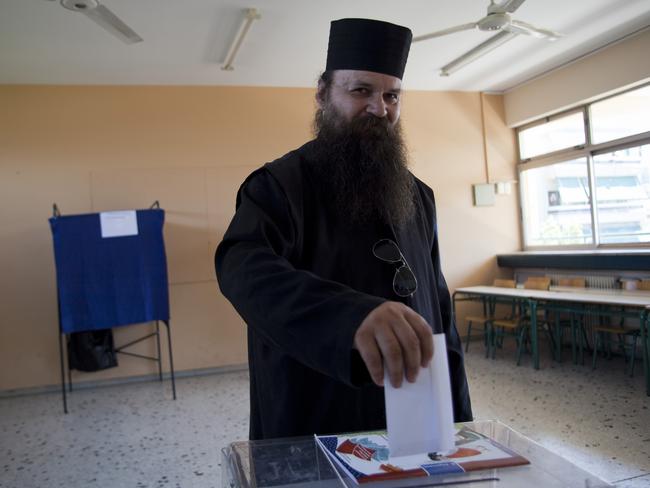 Can’t believe people were happy to vote no ... Father Symeon casts his vote in the Greek referendum. Picture: Supplied.