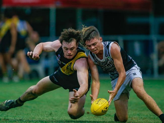 Tigers's Dom Brew and Magpies Ryan Warfe lunge for the ball. Picture: Glenn Campbell