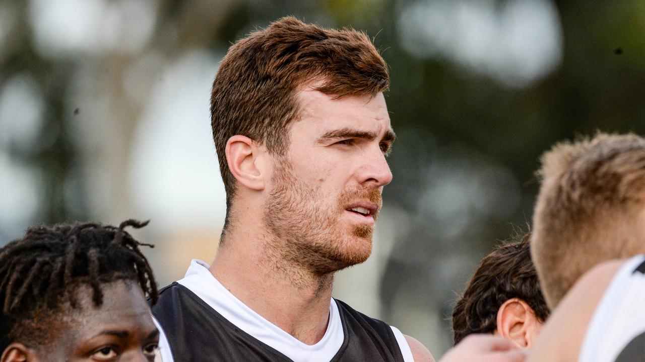 Scott Lycett tunes in during a SANFL game.