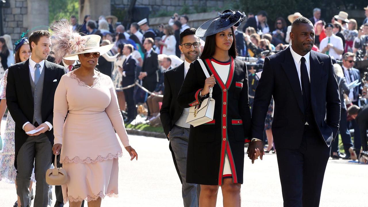 British actor Idris Elba (right) arrives with Sabrina Dhowre, followed by US talk show host Oprah Winfrey and British singer James Blunt on the wedding day in 2018. Picture: Chris Radburn/AFP