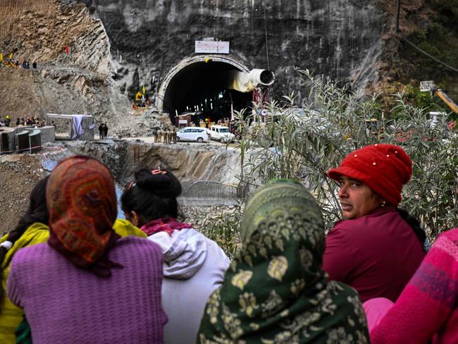 Villagers and locals gather to look at the efforts by the operatives to rescue the 41 men trapped inside the collapsed under construction Silkyara tunnel. Picture: AFP