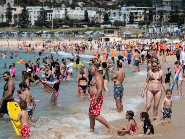 SYDNEY, AUSTRALIA - NewsWire Photos November 29, 2020: People on the sand and in the water on a hot day at Bondi Beach, Sydney. Picture: NCA NewsWire / James Gourley