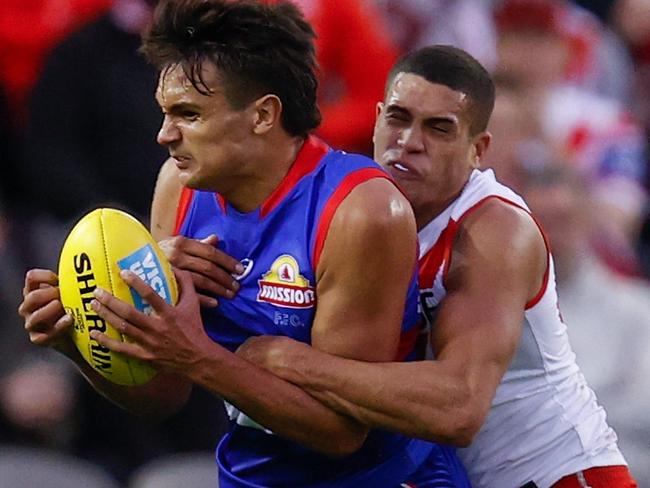 Jamarra Ugle-Hagan gets locked up by James Bell. Picture: AFL Photos/Getty Images