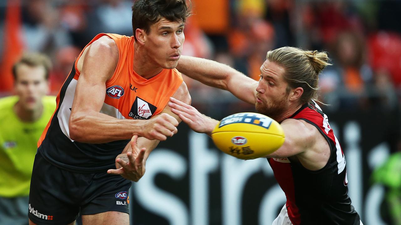 Greater Western Sydney's Rory Lobb handballs ahead of Essendon's Ariel Steinberg during AFL match GWS Giants v Essendon at Spotless Stadium. Picture. Phil Hillyard