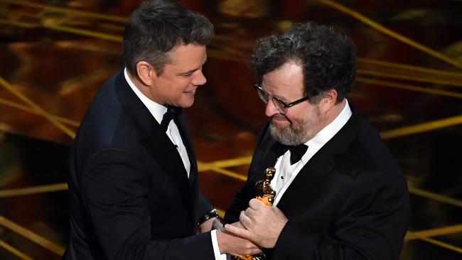 Writer/director Kenneth Lonergan, right, accepts the award from Matt Damon. Picture: Getty