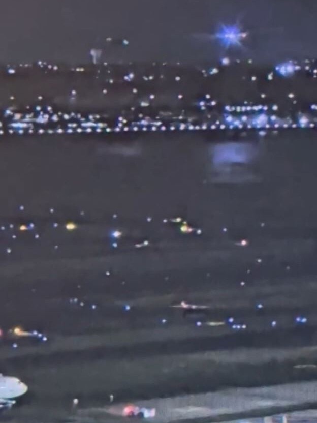 A second set of footage from the airport shows the bright lights of the American jet and the helicopter with its lights on to the left. Picture: CNN.