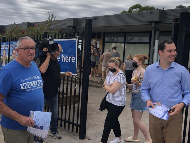 The Liberal candidate for Wakehurst, Toby Williams (right), greets voters in the NSW election at Allambie Heights Public School, with retiring local MP Brad Hazzard, who is the candidate’s former boss. Picture: Jim O'Rourke