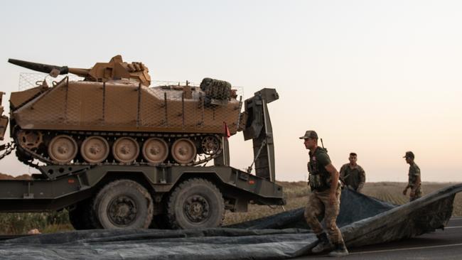 Turkish soldiers prepare armoured vehicles to cross the border into Syria. Picture; Getty Images.