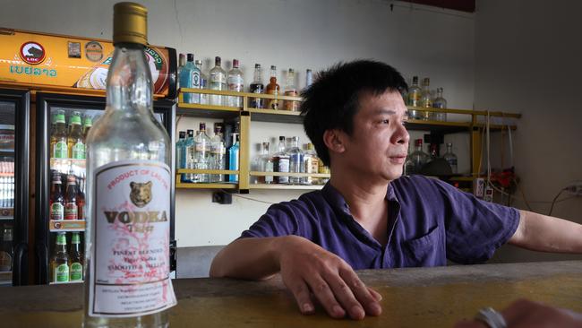 Nana Backpackers Hostel bar tender Toan Van Vanng with a bottle of vodka.