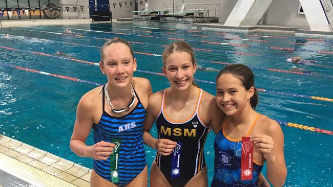 Siena Nicholson, middle, from Mt St Michael's is flanked by fellow place-getters Sofia Brodie, left, and Nicola Vitanza at the CaSSSA swimming carnival.