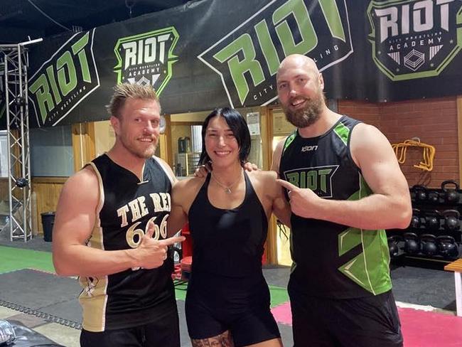 Adelaide's Riot City Wrestling founders Chris and Matt Basso with protégé and WWE Women's World Champion Rhea Ripley in Adelaide. Picture: Supplied